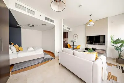 a living room with a bed and a couch at Silkhaus Comfy Studio in Sky Gardens with DIFC Views in Dubai