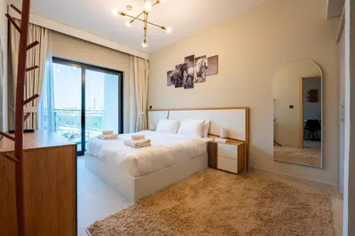 a bedroom with a large bed and a mirror at TRPS - Binghatti Jasmine, JVC - Pool View, Fully Furnished, Prime JVC Location in Dubai