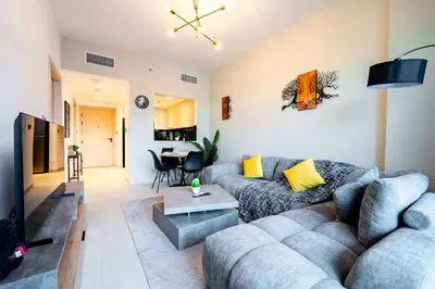 a living room with a couch and a table at TRPS - Binghatti Jasmine, JVC - Pool View, Fully Furnished, Prime JVC Location in Dubai