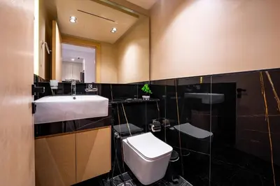 a bathroom with a toilet and a sink at TRPS - Binghatti Jasmine, JVC - Pool View, Fully Furnished, Prime JVC Location in Dubai