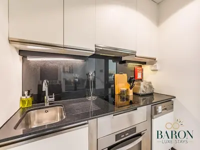 a kitchen with a sink and a counter top at The Muse in Dubai