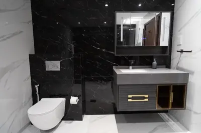 a bathroom with a toilet and a sink and a mirror at Happy Season - Large Terrace- Panoramic View - 2BR JBR Pool Beach in Dubai