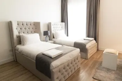 a bedroom with two beds and a large window at Happy Season - Large Terrace- Panoramic View - 2BR JBR Pool Beach in Dubai