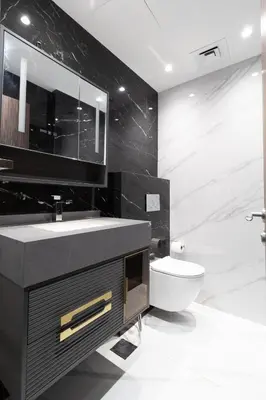 a black bathroom with a sink and a toilet at Happy Season - Large Terrace- Panoramic View - 2BR JBR Pool Beach in Dubai