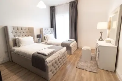 a bedroom with a large bed and a couch at Happy Season - Large Terrace- Panoramic View - 2BR JBR Pool Beach in Dubai