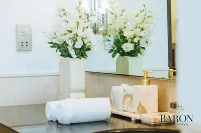 a counter with two vases with white flowers on it at The sleek in Dubai