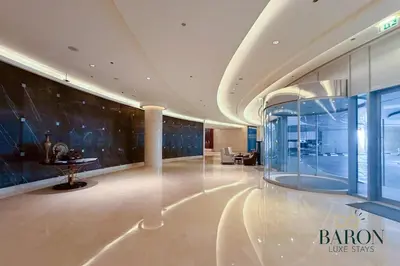 a lobby of a building with a glass wall at The sleek in Dubai