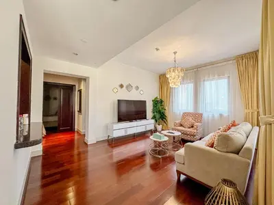 a living room with a couch and a tv at Royal Escape Burj Khalifa View 2BR in Downtown Dubai in Dubai