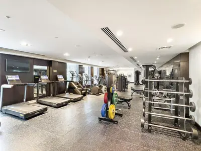a gym with several treadmills and machines in it at FIRST CLASS 2BR Luxury Facing Burj Khalifa in Dubai