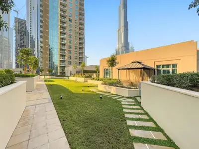 a garden in the middle of a city with buildings at FIRST CLASS 2BR Luxury Facing Burj Khalifa in Dubai