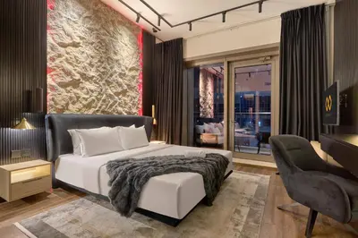 a bedroom with a king sized bed and a desk at Stylish 1BR Apartment with Marina View, Balcony, Pool & Gym Access in Dubai