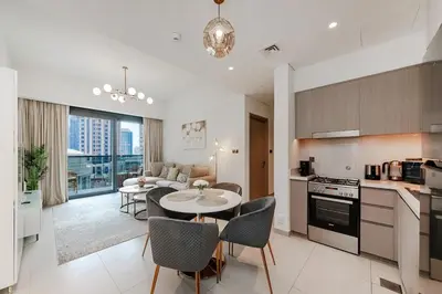 a kitchen and living room with a table and chairs at Act One Act Two Stylish 1BR Near Burj Khalifa & Fountains in Dubai