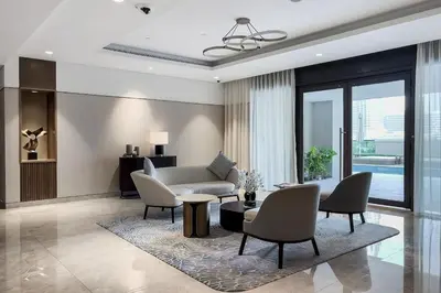 a living room with a couch and chairs and a table at Act One Act Two Stylish 1BR Near Burj Khalifa & Fountains in Dubai