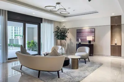 a living room with white chairs and a table at Act One Act Two Stylish 1BR Near Burj Khalifa & Fountains in Dubai