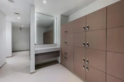 a dressing room with brown cabinets and a mirror at Act One Act Two Stylish 1BR Near Burj Khalifa & Fountains in Dubai