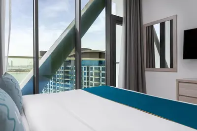 a bedroom with a bed and a large window at Maison Privee - Elegant Palm Retreat with Iconic Sea & Marina Vws in Dubai