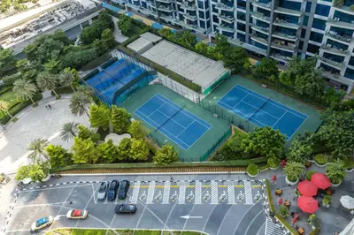 an overhead view of two tennis courts in a city at Maison Privee - Elegant Palm Retreat with Iconic Sea & Marina Vws in Dubai