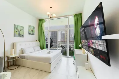 a bedroom with a bed and a large window at Modern Studio With Iconic Burj Khalifa & Canal Views in Dubai