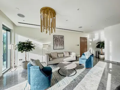 a living room with a couch and chairs and a table at Luxury 2BR with Balcony, Burj Khalifa View & LED Night Show Downtown in Dubai