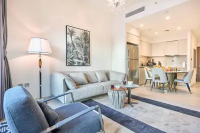 a living room with a couch and a table at Luxury 2BR with Balcony, Burj Khalifa View & LED Night Show Downtown in Dubai