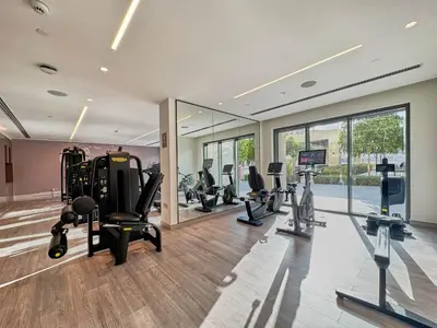 a gym with treadmills and ellipticals in a building at Luxury 2BR with Balcony, Burj Khalifa View & LED Night Show Downtown in Dubai