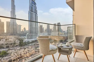 a balcony with chairs and a view of a city at Luxury 2BR with Balcony, Burj Khalifa View & LED Night Show Downtown in Dubai