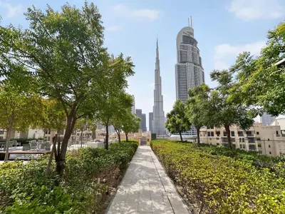 a walkway in the city with a view of the skyscrapers at CH Cozy & Luxury 1BR Apt in the Heart of Downtown in Dubai