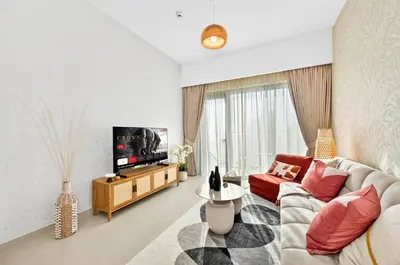 a living room with a couch and a tv at CH Cozy & Luxury 1BR Apt in the Heart of Downtown in Dubai