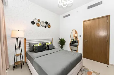 a bedroom with a bed and a mirror and a closet at CH Cozy & Luxury 1BR Apt in the Heart of Downtown in Dubai