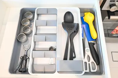 a drawer filled with scissors and other kitchen utensils at CH Cozy & Luxury 1BR Apt in the Heart of Downtown in Dubai