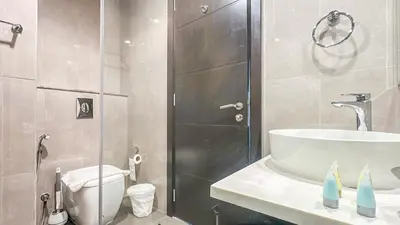 a bathroom with a shower and a toilet and a sink at Modern 1BR in Merano, Near Downtown & Burj Khalifa - 14AB07 in Dubai