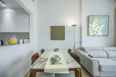 a living room with a table and a couch at Modern 1BR in Binghatti Luna, JVC District in Dubai