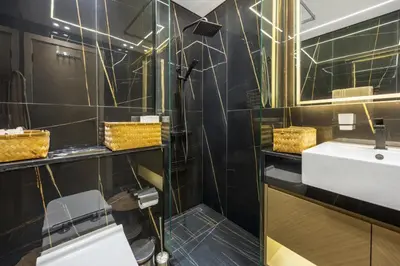 a bathroom with a sink and a mirror at Modern 1BR in Binghatti Luna, JVC District in Dubai