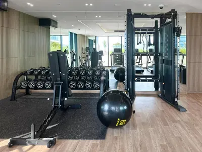 a gym with a bunch of equipment in a room at Modern 1BR in Binghatti Luna, JVC District in Dubai