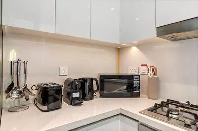 a kitchen with a counter top with a microwave at Luxury 4BR with full Burj Khalifa and Fountain View - 5Min to Dubai Mall in Dubai