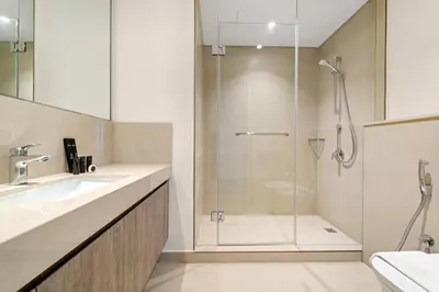 a bathroom with a glass shower and a sink at Luxury 4BR with full Burj Khalifa and Fountain View - 5Min to Dubai Mall in Dubai