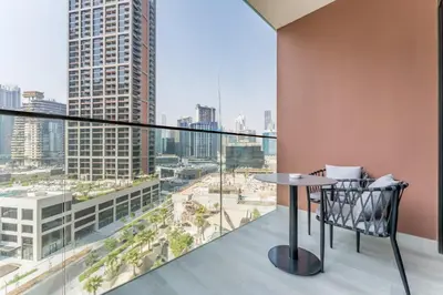 a balcony with a table and a view of the city at Furnished Studio with Burj Khalifa View, Near Dubai Water Canal, with Easy Access to Downtown, Peninsula Five - 3, Business Bay by Deluxe Holiday Homes in Dubai