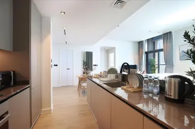 a kitchen with a long counter with a sink at Chic 1B by Dubai Canal Marasi Drive with Pool, Gym in Dubai
