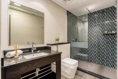 a bathroom with a sink and a toilet and a shower at GuestReady - Spectacular Marina Views | High Floor in Dubai