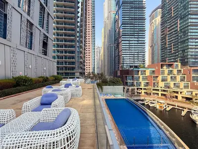 a hotel with a pool and chairs and buildings at GuestReady - Spectacular Marina Views | High Floor in Dubai