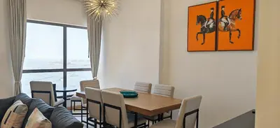 a dining room with a table and a horse painting on the wall at Deluxe Spacious 2BR on JBR Beach, Full Dubai Eye and Panoramic Sea Views - By Sunkised Holiday Homes in Dubai