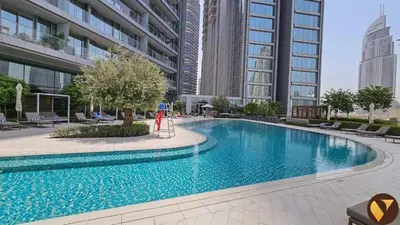a large swimming pool in the middle of a building at Vogue Downtown Vida Dubai Mall, Direct Access to Dubai Mall via Climate Controlled bridge, Two Bedroom Apartment with Full Burj Khalifa View from Balcony and Access to all Amenities in Dubai