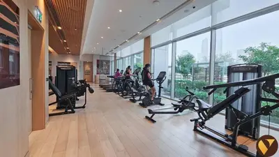 a gym with a row of treadmills and people working out at Vogue Downtown Vida Dubai Mall, Direct Access to Dubai Mall via Climate Controlled bridge, Two Bedroom Apartment with Full Burj Khalifa View from Balcony and Access to all Amenities in Dubai