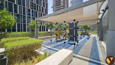 a building with a canopy with benches and buildings at Vogue Downtown Vida Dubai Mall, Direct Access to Dubai Mall via Climate Controlled bridge, Two Bedroom Apartment with Full Burj Khalifa View from Balcony and Access to all Amenities in Dubai
