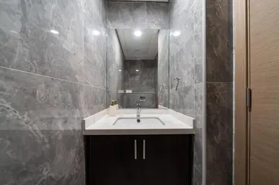 a bathroom with a sink and a mirror at Chic and Bright JVC 1 Bed in Catch Residences in Dubai