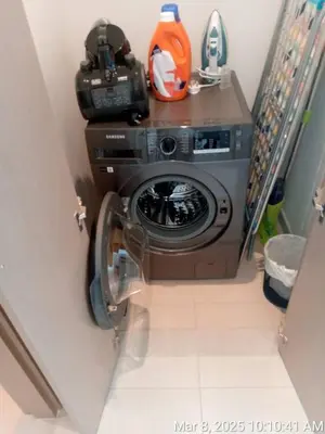 a washing machine in a bathroom with a camera at Highest floor - 5 mins walk to Dubai Mall and Burj Khalifa in Dubai
