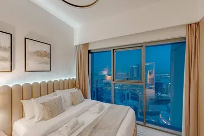 a bedroom with a bed and a large window at Highest floor - 5 mins walk to Dubai Mall and Burj Khalifa in Dubai
