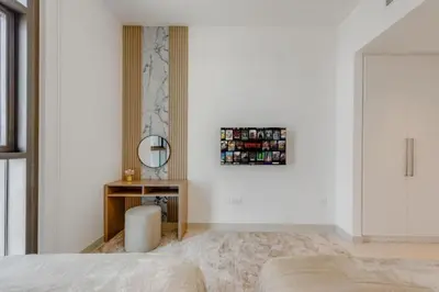 a bedroom with a bed and a mirror and a table at Walk to Dubai Mall and Burj Khalifa Luxury 2 Bed - sleep up to 10 in Dubai