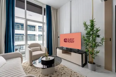 a living room with a couch and a tv at GuestReady - Spacious 1Bed l Near Butterfly Garden in Dubai