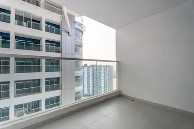 an empty apartment balcony with a view of a building at GuestReady - Spacious 1Bed l Near Butterfly Garden in Dubai